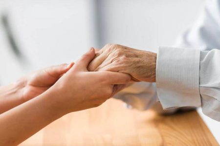 Power Employment: nurse-holding-senior-man-s-hands-comfor